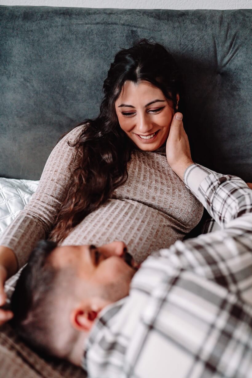 babybauchshooting-paar-auf-dem-bett-moehlin